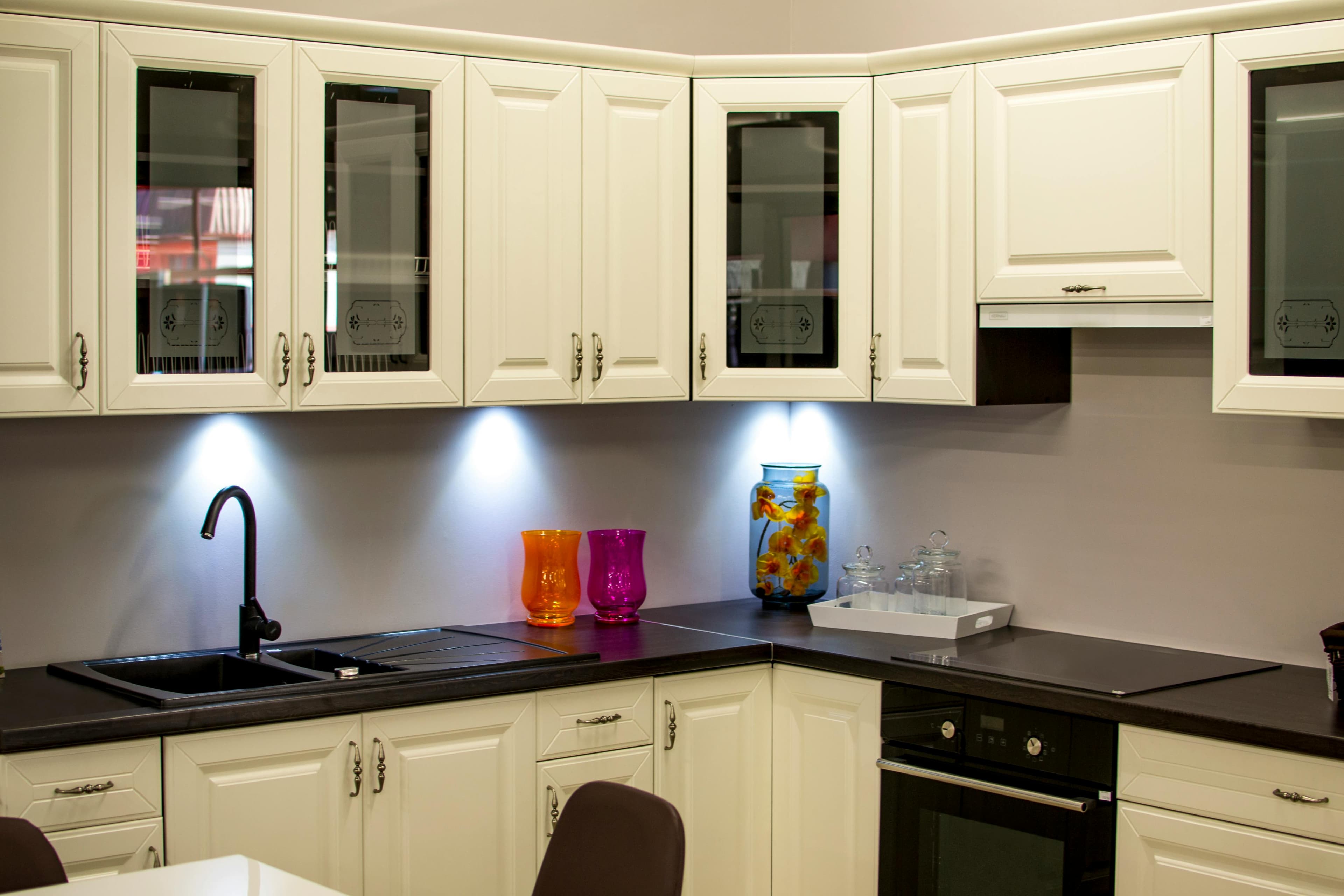 Freshly refinished white kitchen cabinets with modern hardware