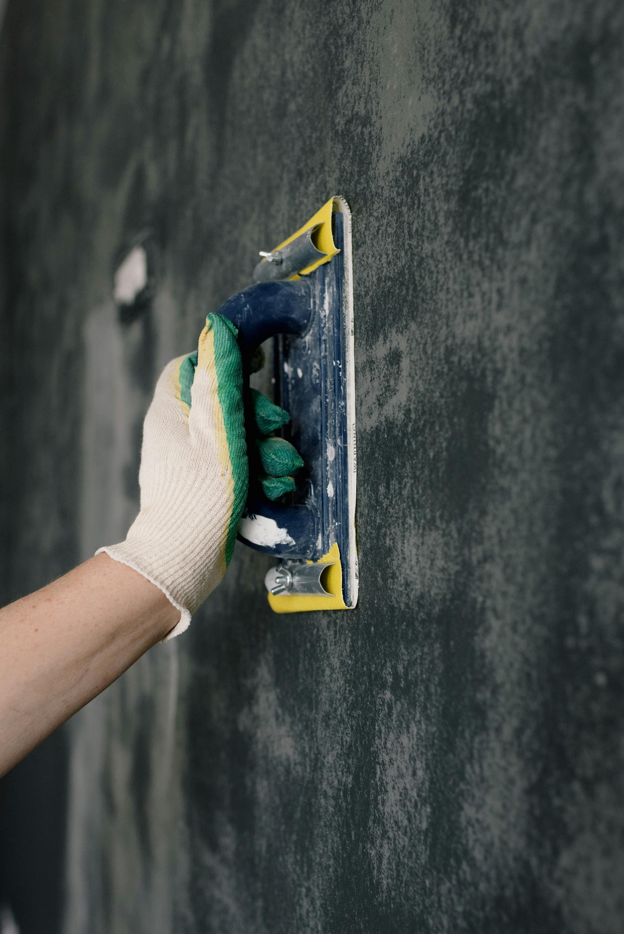 Odds & Ends handyman patching drywall in a living room
